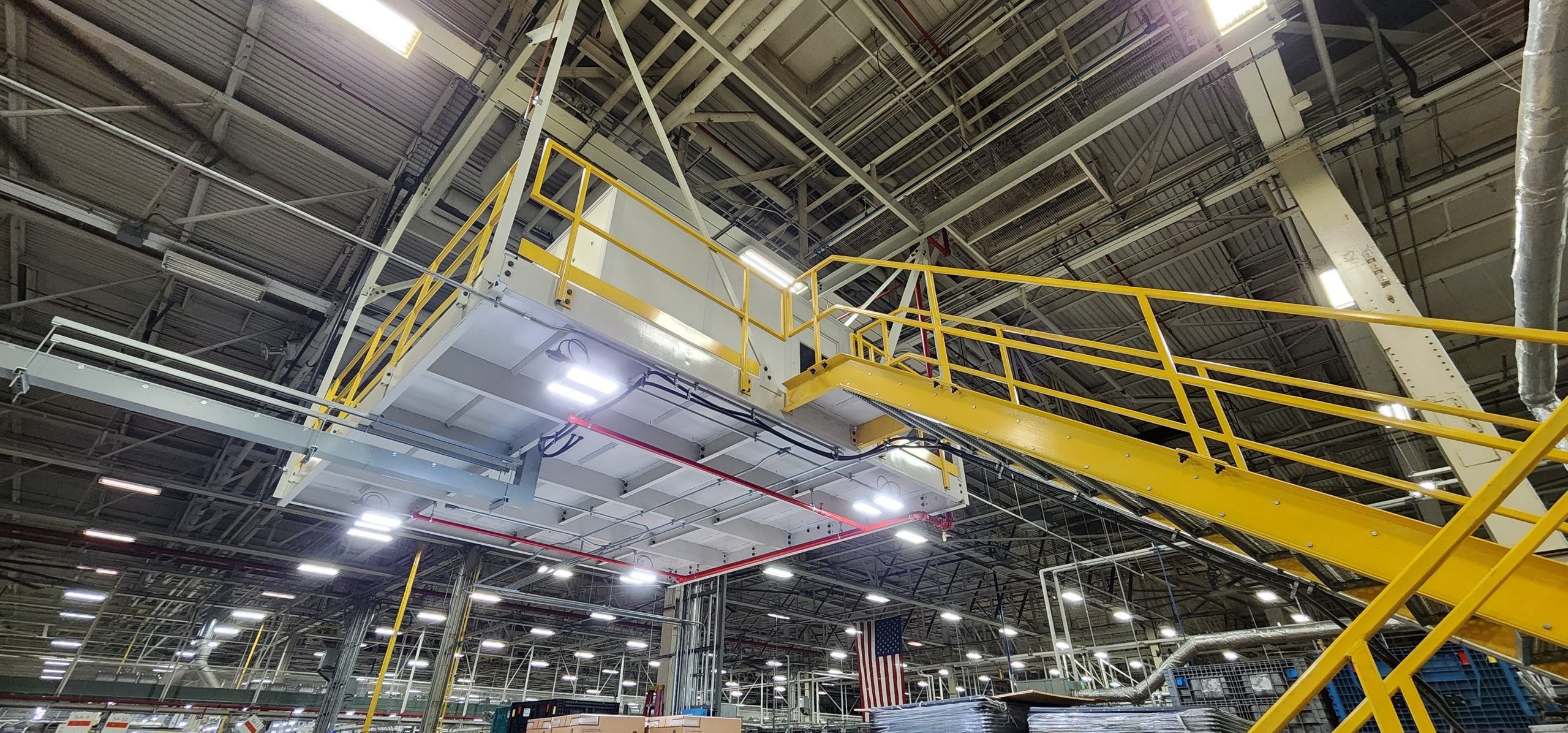 Industrial access stair design with safety-yellow handrails